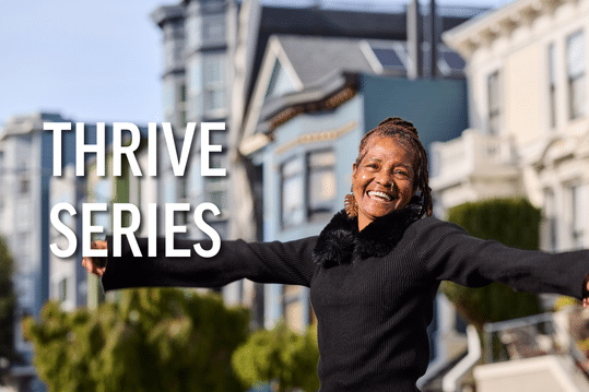 Woman smiling with arms wide open in San Francisco
